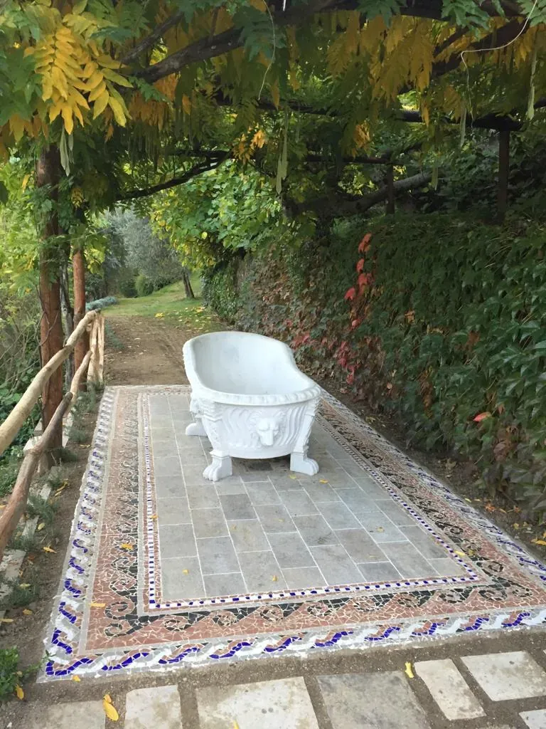 The marble bath on its mosaic carpet