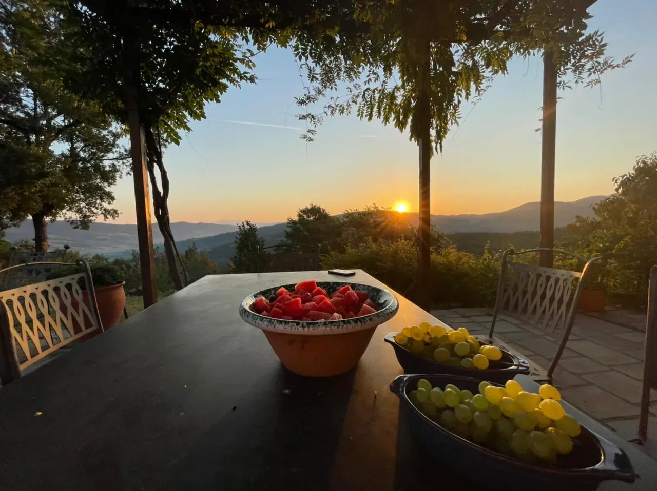 A table set at sunset with tomatoes and lemons